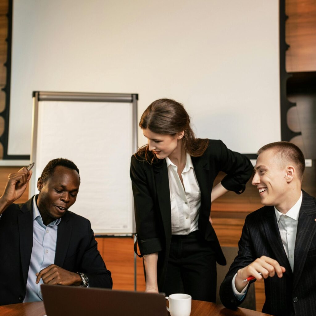 A diverse group of professionals engaged in teamwork during a business meeting.